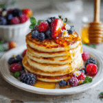Cottage cheese pancakes with berries and honey