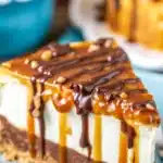 Delicious Turtle Cheesecake topped with caramel, chocolate ganache, and pecans.