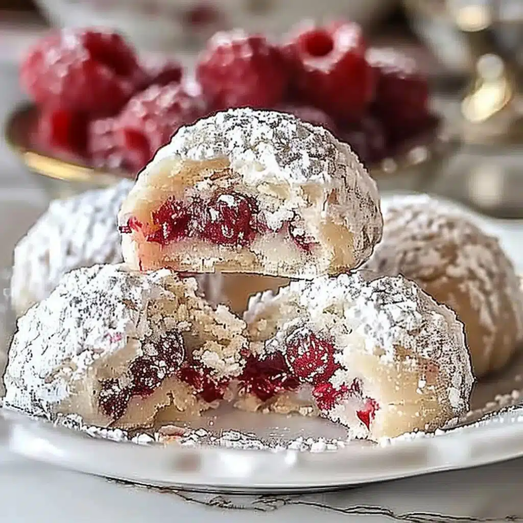 Raspberry Almond Snowball Cookies Delightful Easy Recipe 4 Raspberry Almond Snowball Cookies decorated with powdered sugar on a plate